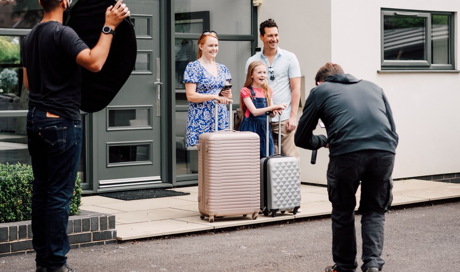An Ordernised crew photographing a family on location outside their home