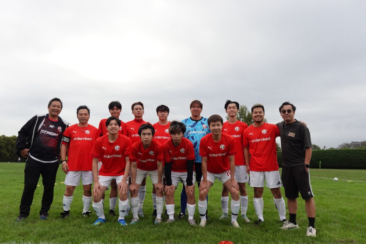 The Ordernised team in their sponsored red kit before a grassroots football match