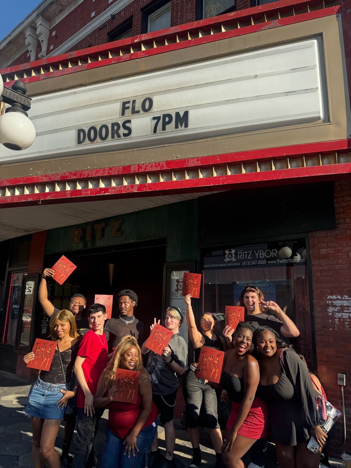 Fans outside a venue under a sign reading FLO, doors 7pm