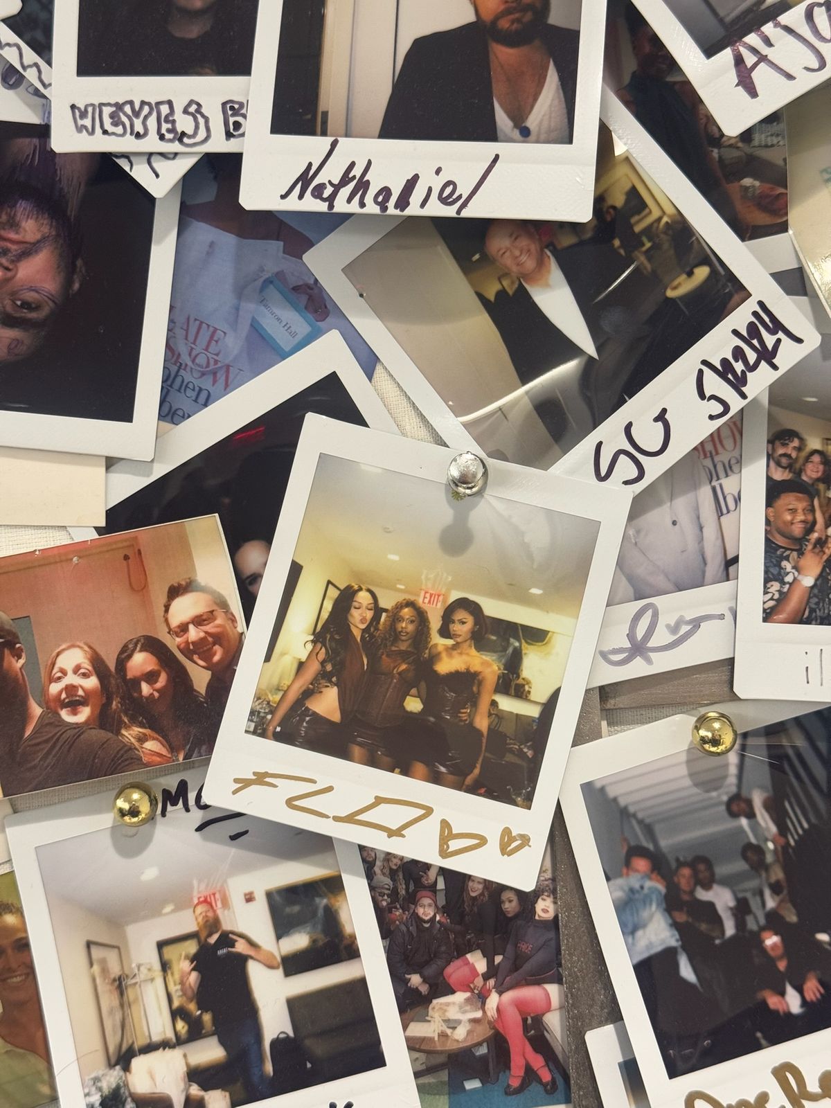 A pile of signed polaroids from tour