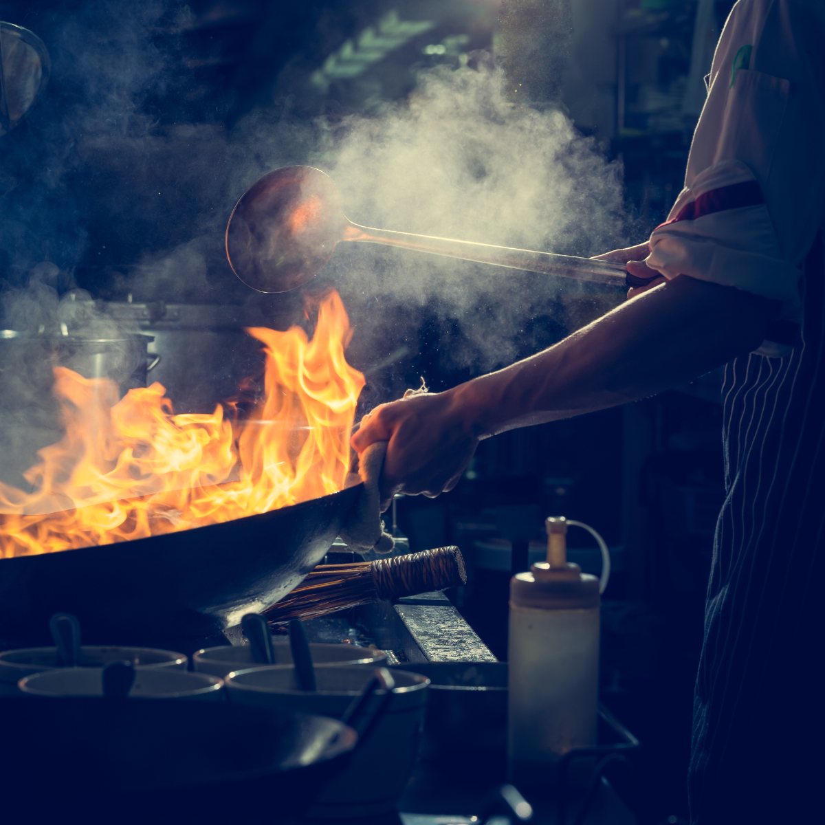 A chef working a wok during service